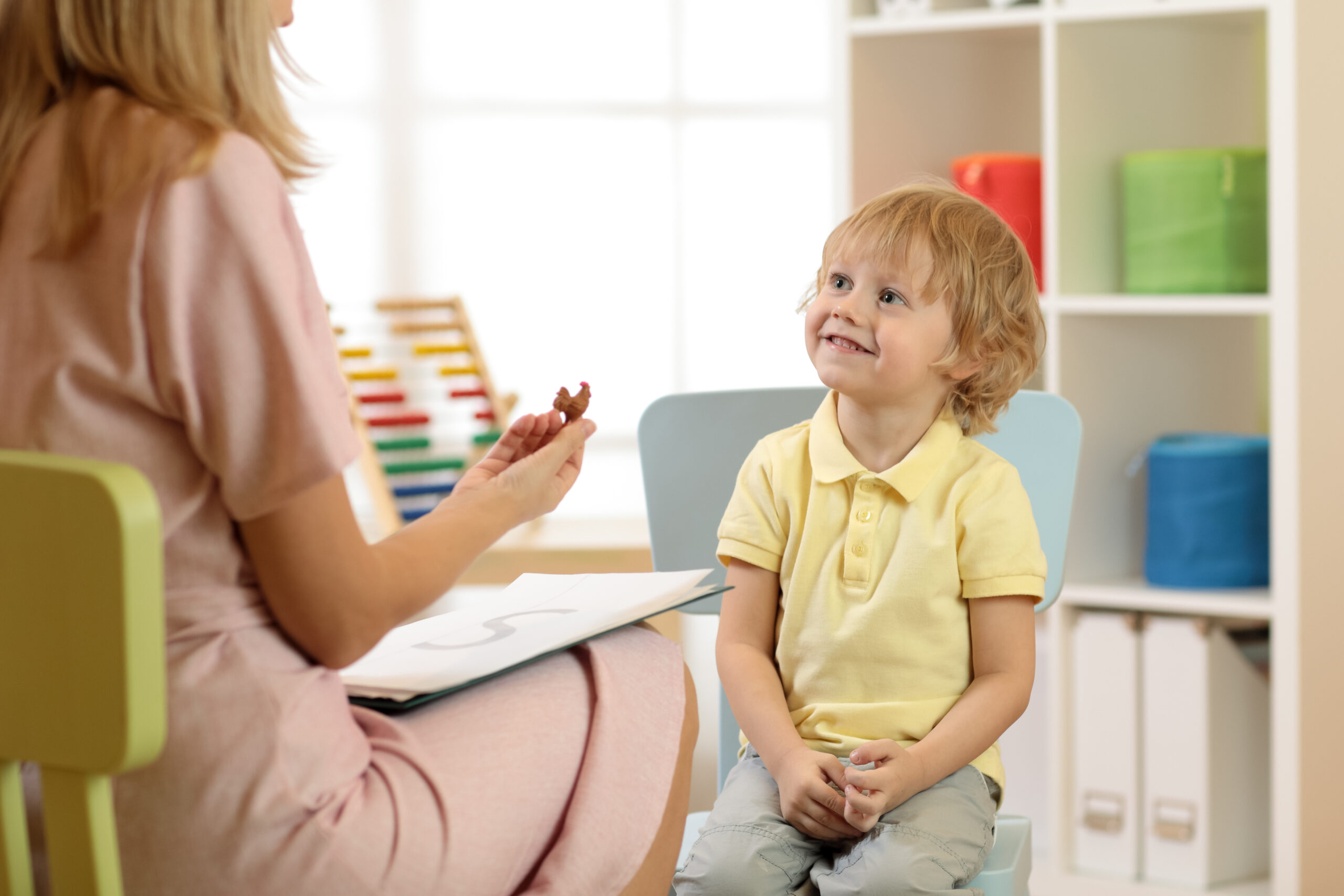 Cute little child boy at speech therapist office