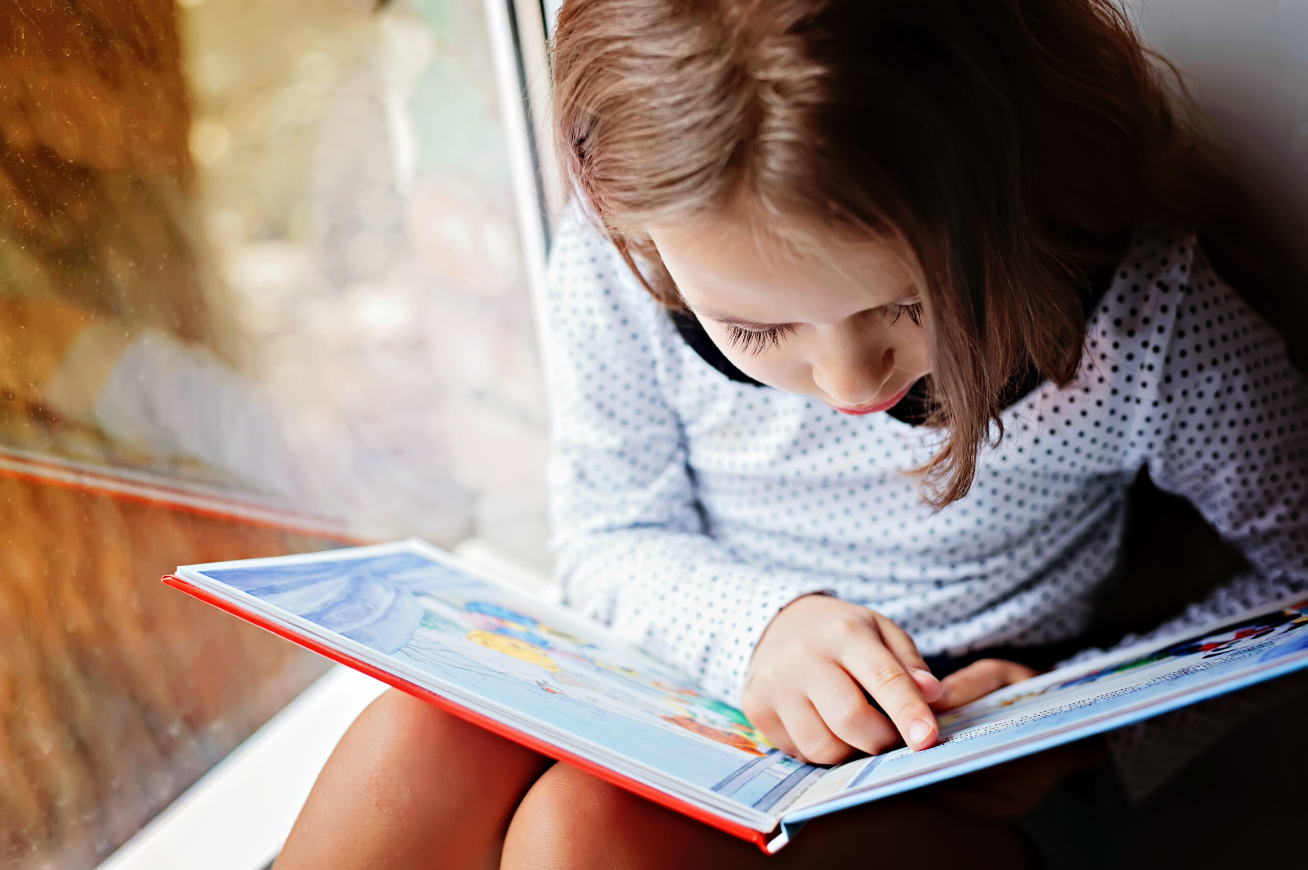 toddler girl with book